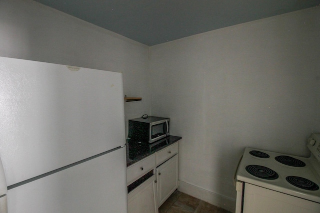 kitchen featuring white cabinets and white appliances