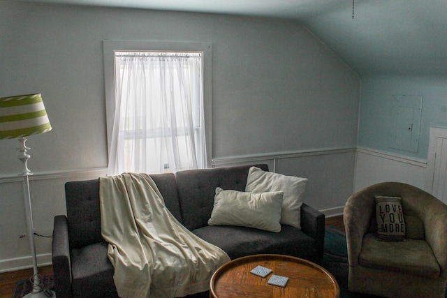 living room featuring hardwood / wood-style flooring, electric panel, and vaulted ceiling