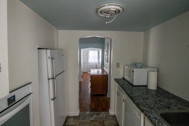 kitchen with white appliances and white cabinets