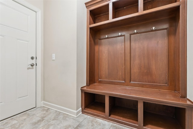 mudroom with light tile patterned floors and baseboards