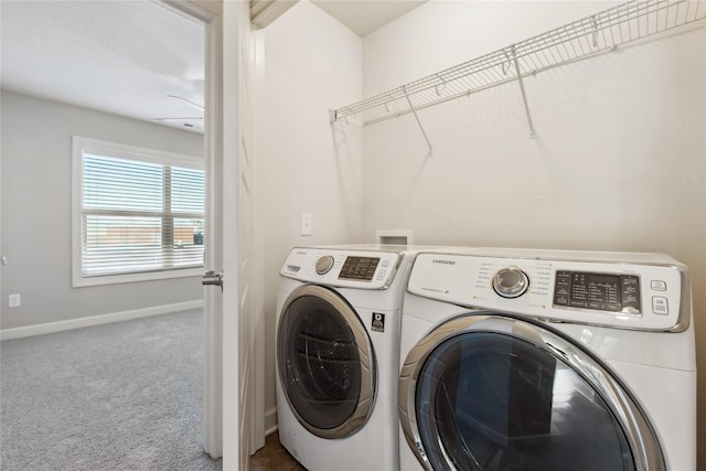 washroom featuring carpet flooring, separate washer and dryer, baseboards, and laundry area