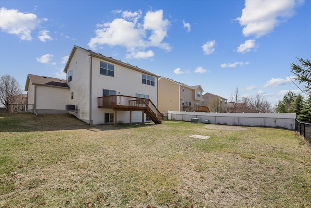 rear view of house with a wooden deck, a yard, fence private yard, stairway, and central AC unit