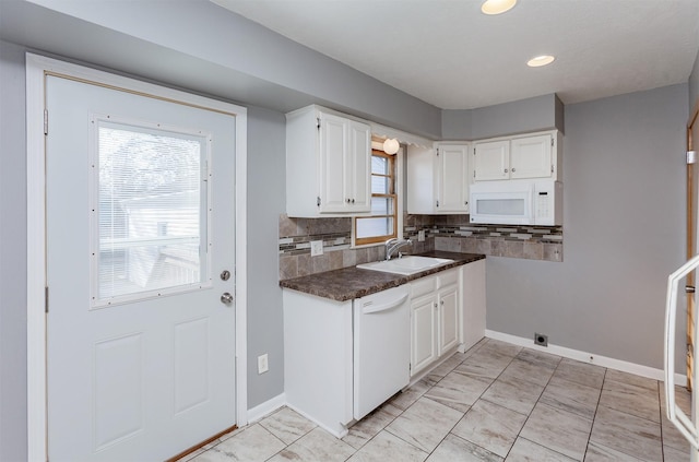 kitchen with white cabinetry, sink, white appliances, and decorative backsplash