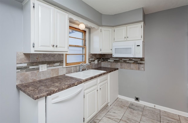 kitchen featuring backsplash, sink, white appliances, and white cabinets