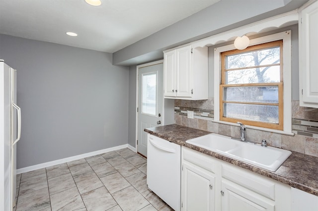 kitchen with sink, backsplash, white cabinets, light tile patterned floors, and white appliances