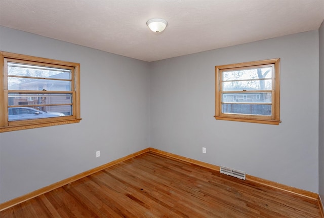 unfurnished room featuring wood-type flooring