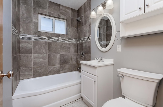 full bathroom with toilet, vanity, and tiled shower / bath