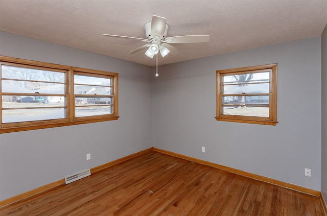 empty room featuring ceiling fan and wood-type flooring