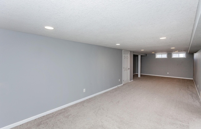 basement with carpet flooring and a textured ceiling