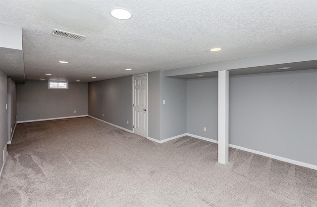 basement with carpet and a textured ceiling