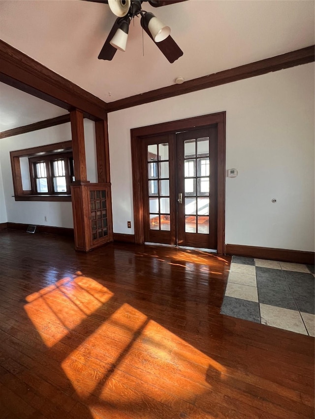 spare room with crown molding, ceiling fan, dark hardwood / wood-style flooring, and french doors