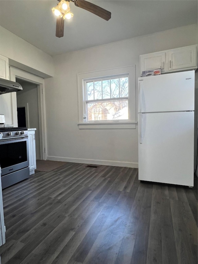 kitchen featuring dark hardwood / wood-style floors, white cabinetry, white fridge, ceiling fan, and stainless steel gas range oven