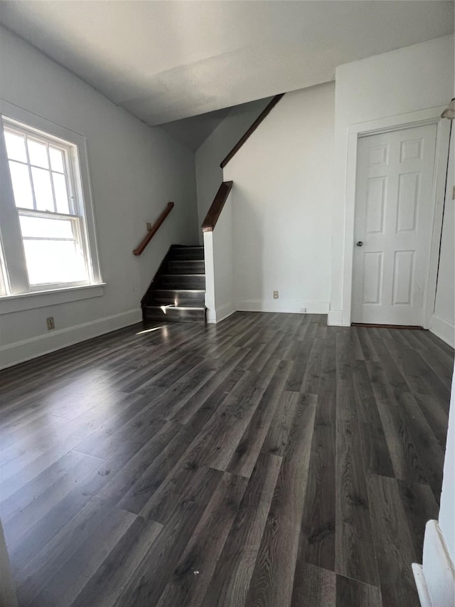 unfurnished living room featuring dark hardwood / wood-style flooring