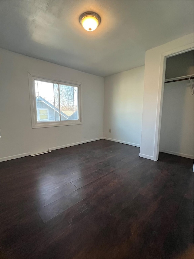 unfurnished bedroom with dark hardwood / wood-style floors