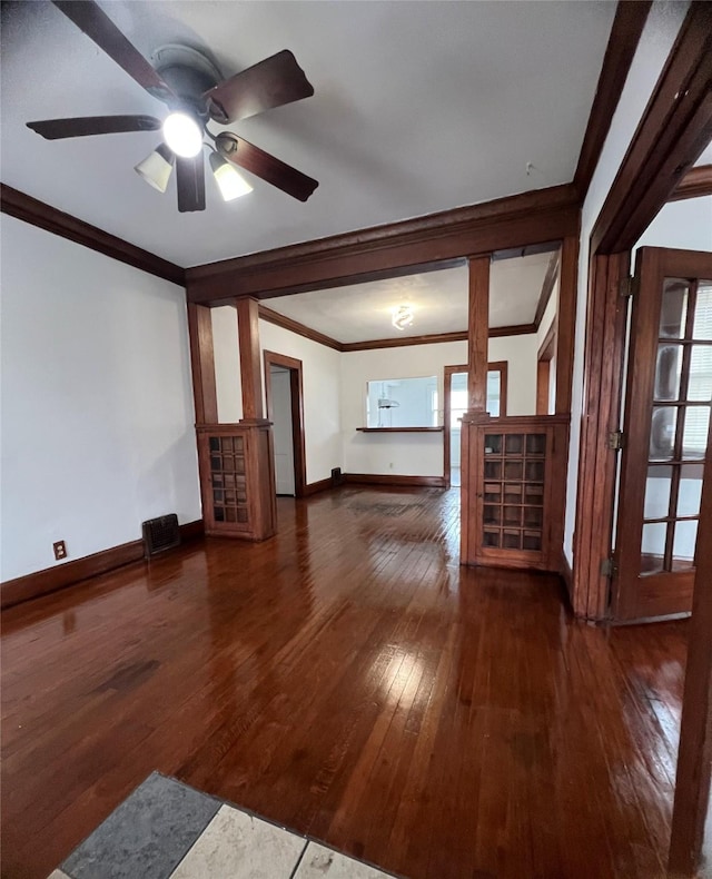 unfurnished living room featuring crown molding, dark hardwood / wood-style floors, and ceiling fan