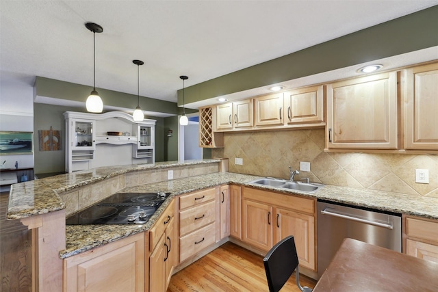 kitchen with stainless steel dishwasher, a sink, and light brown cabinetry