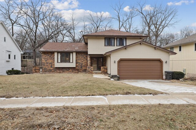 view of front facade with brick siding, an attached garage, driveway, and a front yard