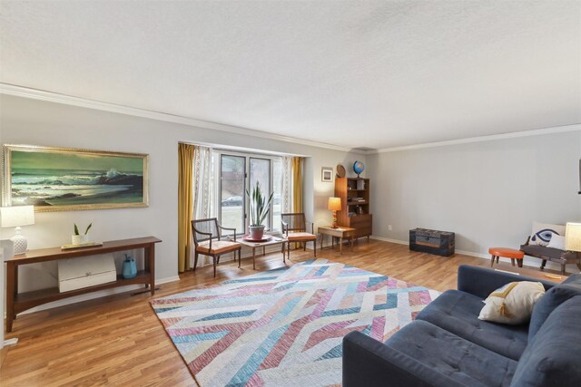 living room featuring crown molding, baseboards, and wood finished floors