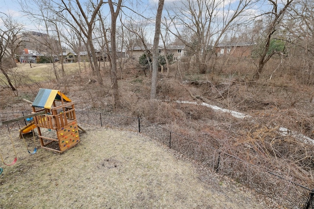 view of yard featuring a playground and fence