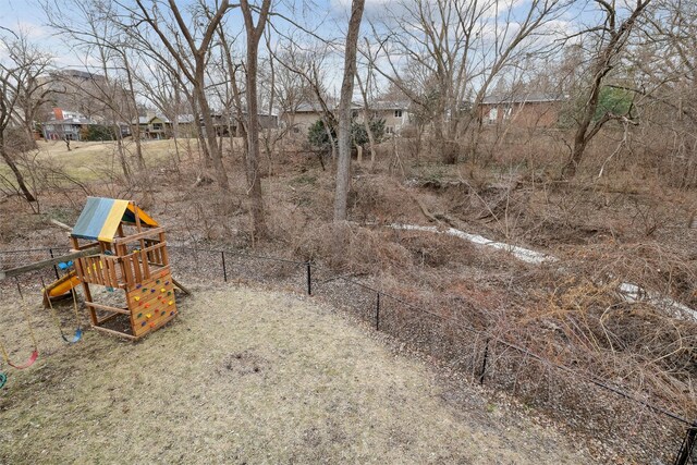 view of yard with a playground and fence