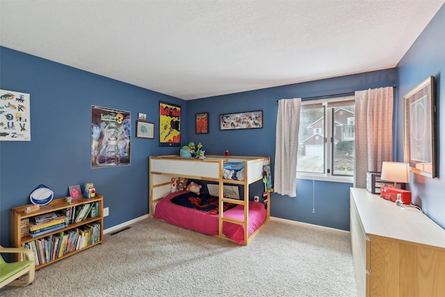 carpeted bedroom with baseboards, visible vents, and a textured ceiling