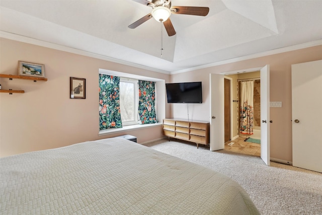 bedroom with baseboards, carpet floors, a tray ceiling, ceiling fan, and ornamental molding