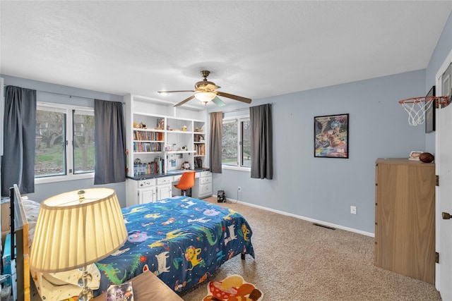 carpeted bedroom featuring ceiling fan, baseboards, and visible vents