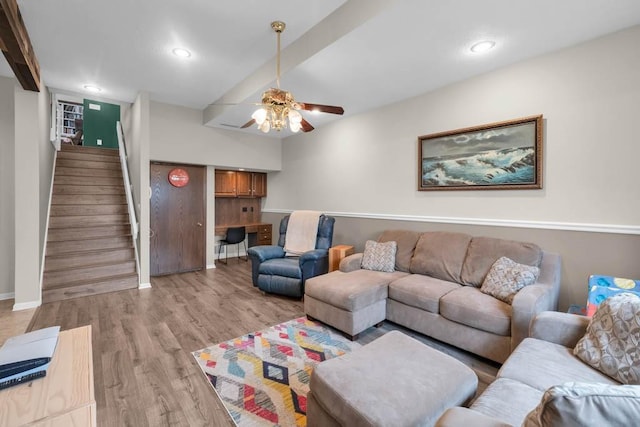 living area with light wood-type flooring, baseboards, recessed lighting, stairs, and ceiling fan