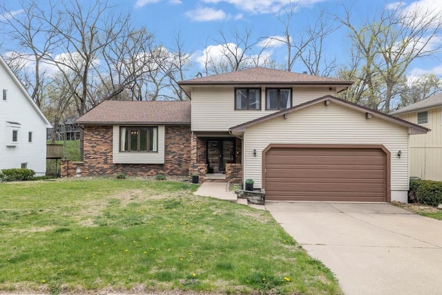 split level home featuring a shingled roof, an attached garage, driveway, brick siding, and a front yard