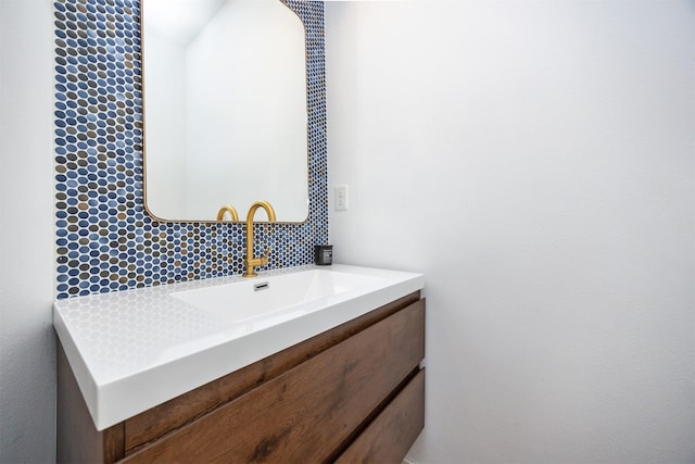bathroom featuring vanity and tasteful backsplash