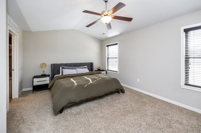 bedroom with lofted ceiling, visible vents, light carpet, and baseboards