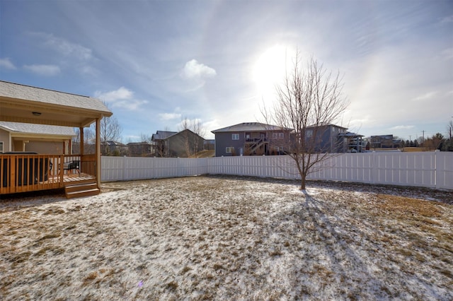 view of yard featuring fence and a deck