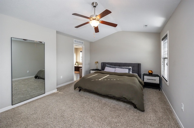 carpeted bedroom featuring lofted ceiling, a ceiling fan, visible vents, and baseboards