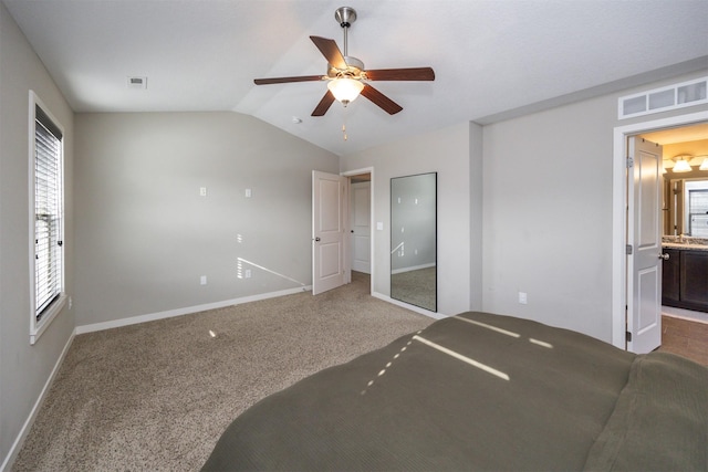 unfurnished bedroom featuring vaulted ceiling, carpet flooring, visible vents, and baseboards