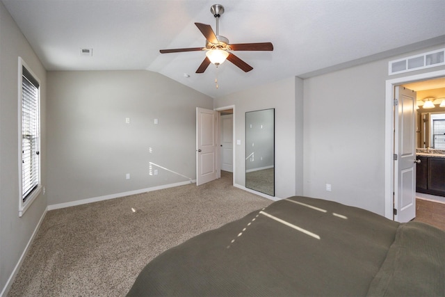 bedroom featuring baseboards, vaulted ceiling, and visible vents