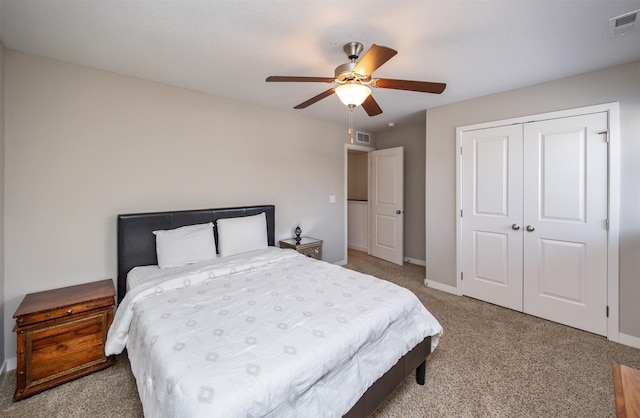 carpeted bedroom with baseboards, a ceiling fan, visible vents, and a closet