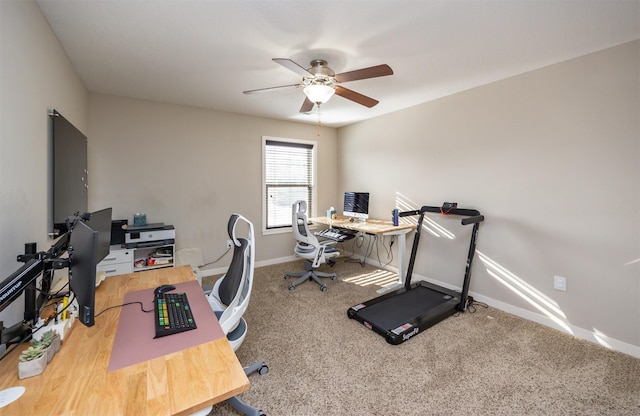 carpeted office featuring baseboards and ceiling fan