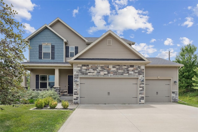 16924 Prairie Dr, Clive, IA 50325 - craftsman-style home featuring stone siding, an attached garage, driveway, and covered porch