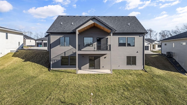 rear view of property featuring a yard, a patio area, and central air condition unit