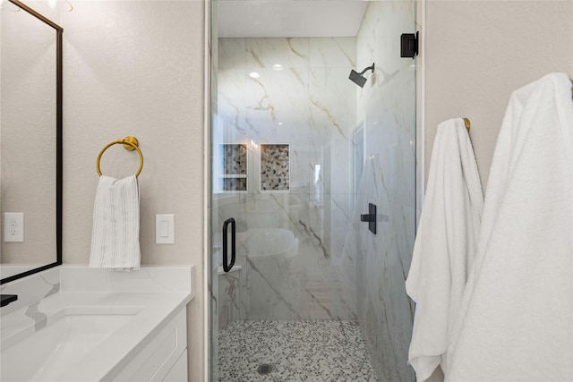 bathroom with vanity and a shower with door