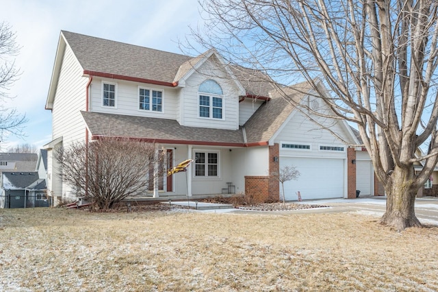 traditional-style house featuring a garage, brick siding, a shingled roof, and concrete driveway