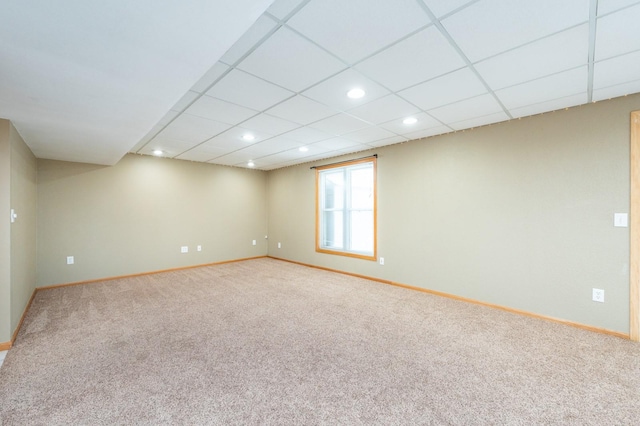 spare room featuring a drop ceiling, recessed lighting, baseboards, and carpet floors