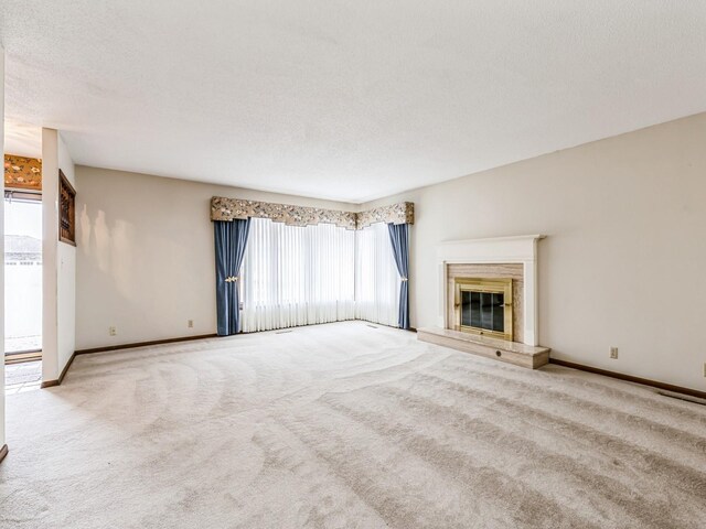 unfurnished living room featuring light colored carpet and a textured ceiling