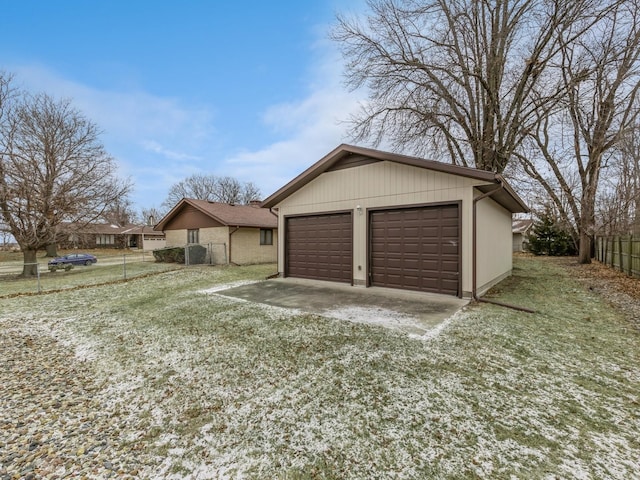 detached garage featuring fence