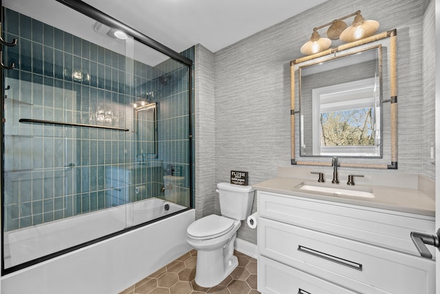 full bathroom with vanity, combined bath / shower with glass door, tile patterned floors, and toilet