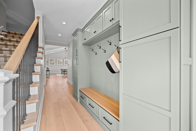 mudroom with lofted ceiling and light hardwood / wood-style flooring