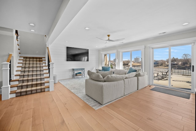 living room with ceiling fan and light hardwood / wood-style floors