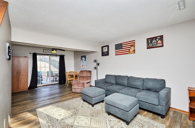 living room with hardwood / wood-style floors and a textured ceiling