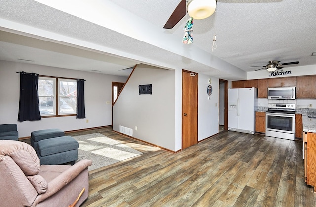 living room featuring a textured ceiling, dark hardwood / wood-style floors, and ceiling fan