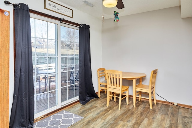 dining area featuring hardwood / wood-style flooring and ceiling fan